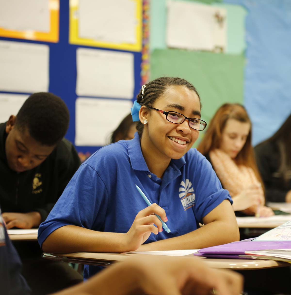 Student drawing in a classroom.