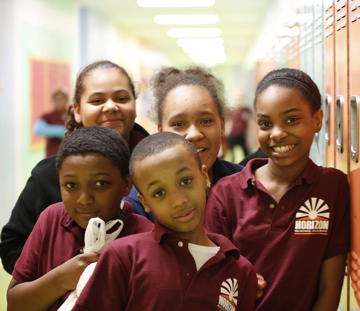 Teacher or school staff member warmly interacting with a student outside
